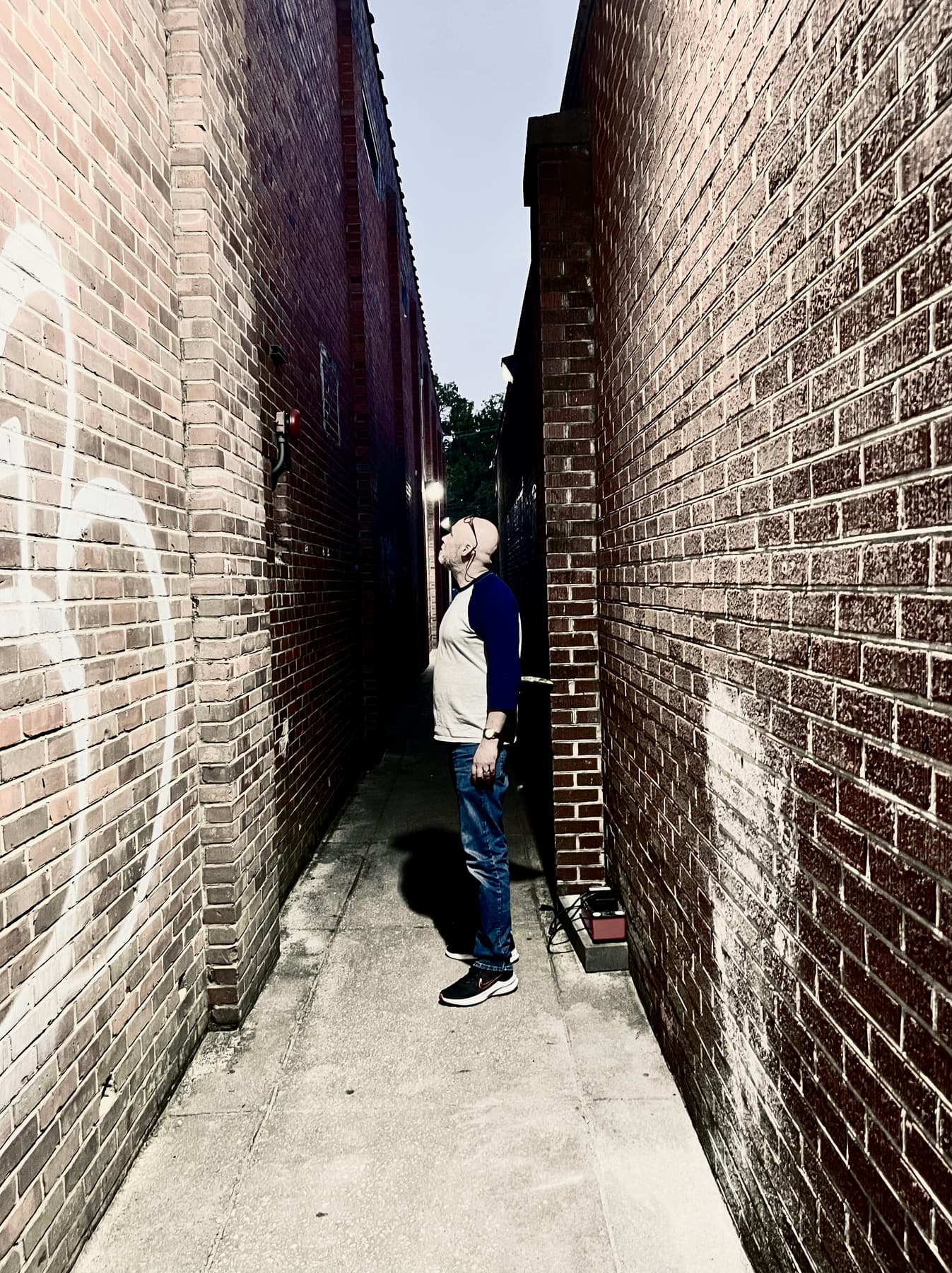 Kevin Keck standing in a brick alley